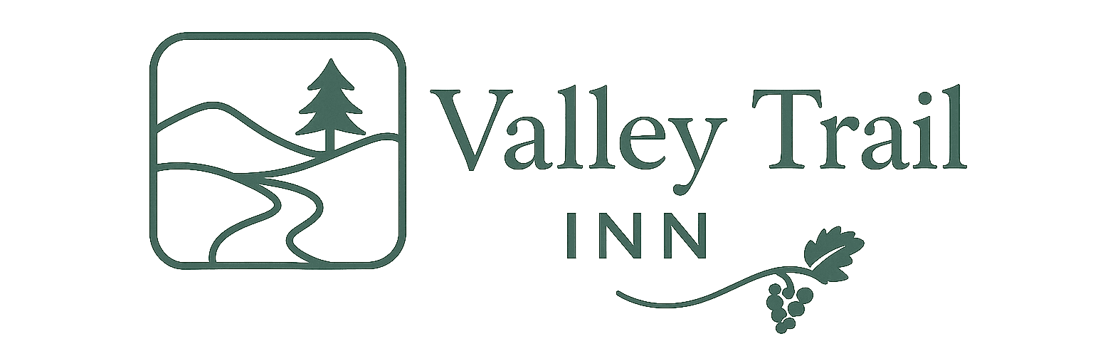 Logo of Valley Trail Inn featuring a tree, mountains, and a vine graphic.